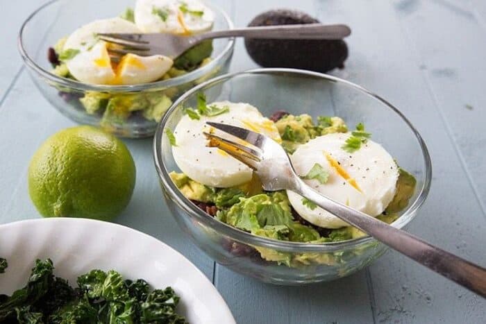 two servings of Tex Mex Kale Breakfast Goal Bowl with poached eggs on top