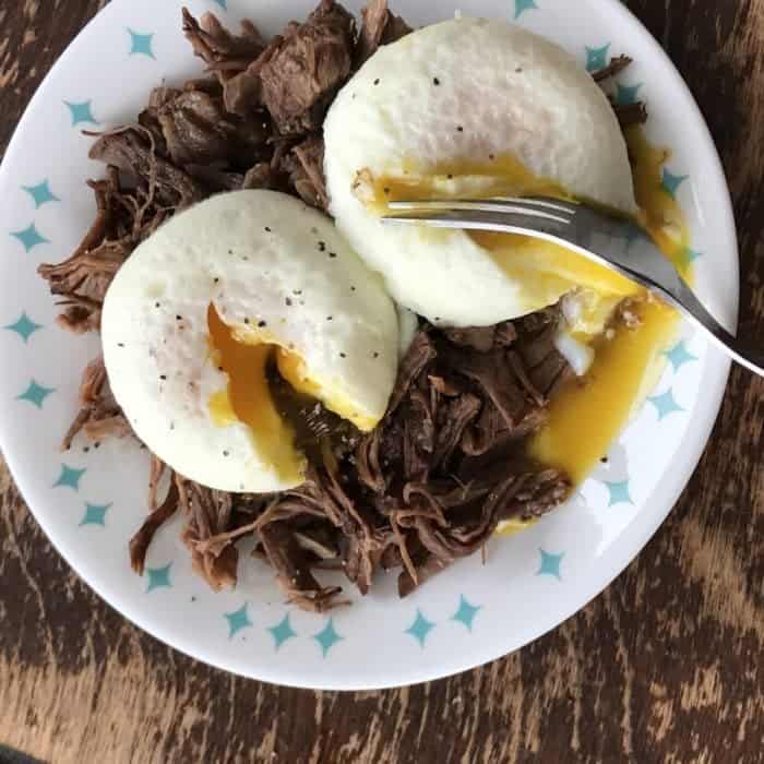 a plate of instant pot beef roast with eggs on top