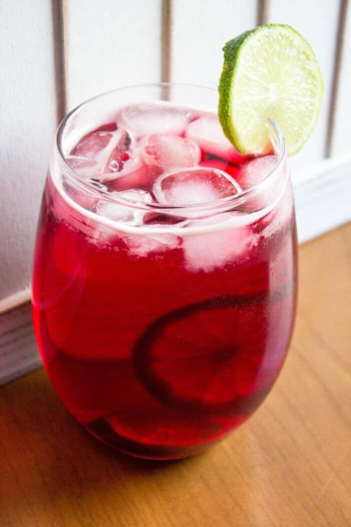 Close up of Glass with Cranberry Zombie Drink with Slices of Lime