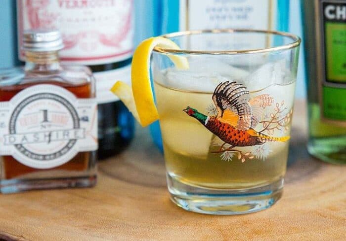 Bijou Cocktail in Pheasant glass garnish with twisted lemon peel