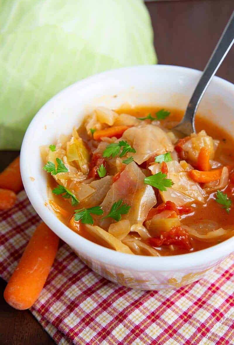 cabbage soup in a bowl garnish with parsley leaves