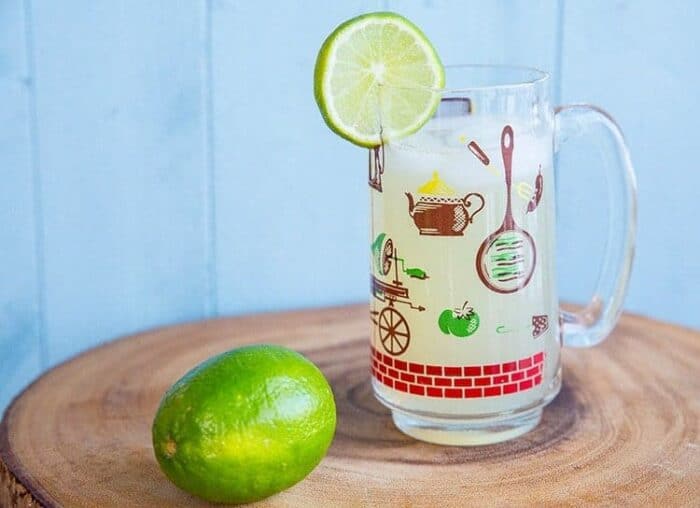 Classic Moscow Mule in a beer mug with ice, garnish with slice of lime