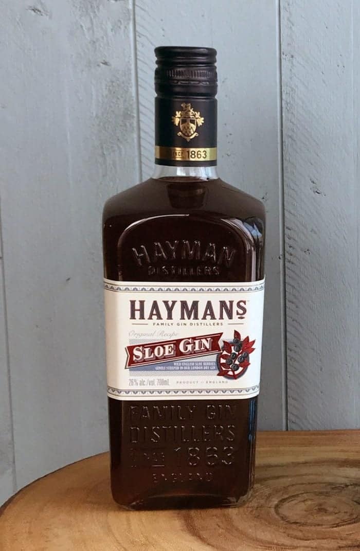 a bottle of Hayman's Sloe Gin on wood