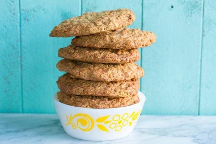 Butterscotch Oaties, AKA Oatmeal Scotchies Cookies in a white bowl on jade blue wood background