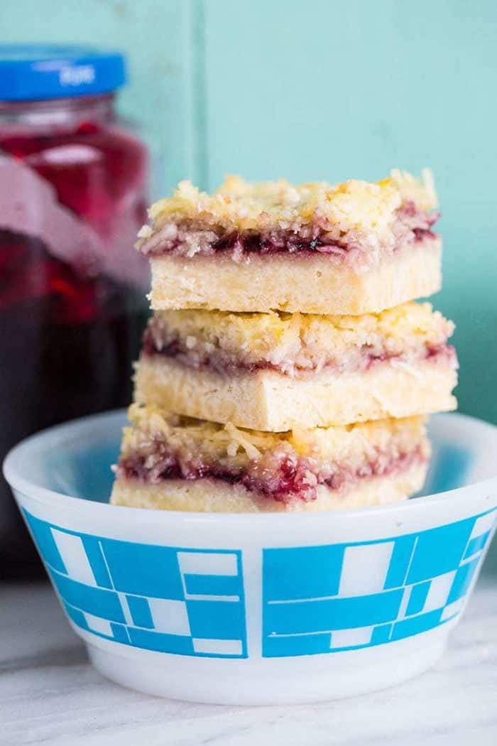 Close up Stack of Coconut Grape Jam Bars in a White bow printed with blue