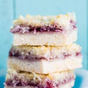 Close up Stack of Coconut Grape Jam Bars in a White bow printed with blue