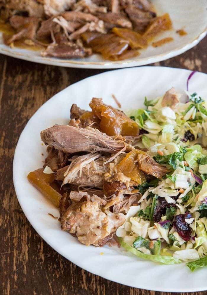 Crockpot Pulled Pork served with onions in a white plate