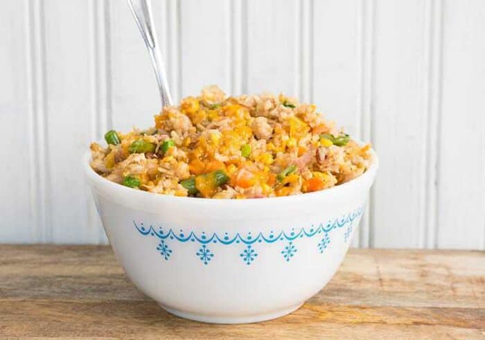 Fried Rice in a white bowl with spoon in it ready to be enjoy!