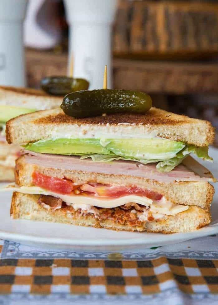 Clubhouse Sandwich topped with Gherkins pickles