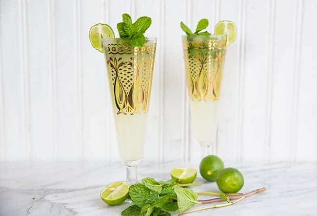 Key Lime Mojito in pilsners with gold prints garnish with fresh mint and lime