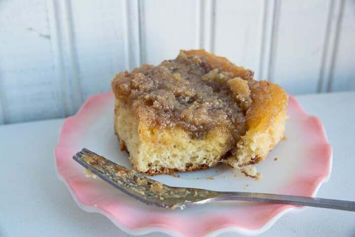 A Slice of Brown Sugar Caramel Cream Cinnamon Buns in Ruffle Plate with Fork