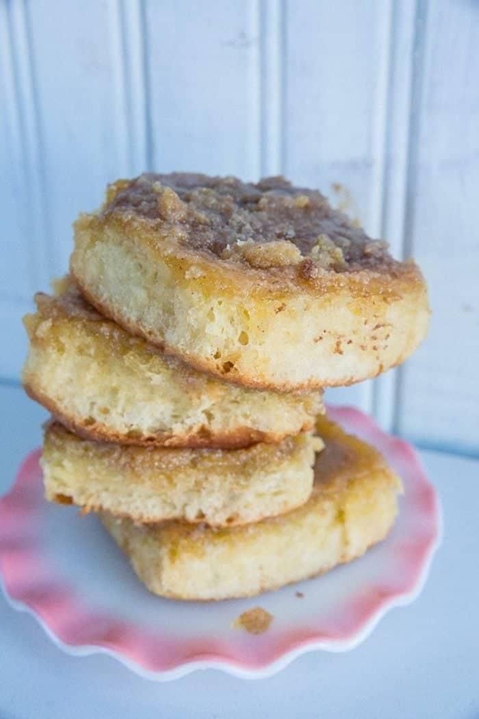 Stack of Brown Sugar Caramel Cream Cinnamon Buns in White Ruffle Plate