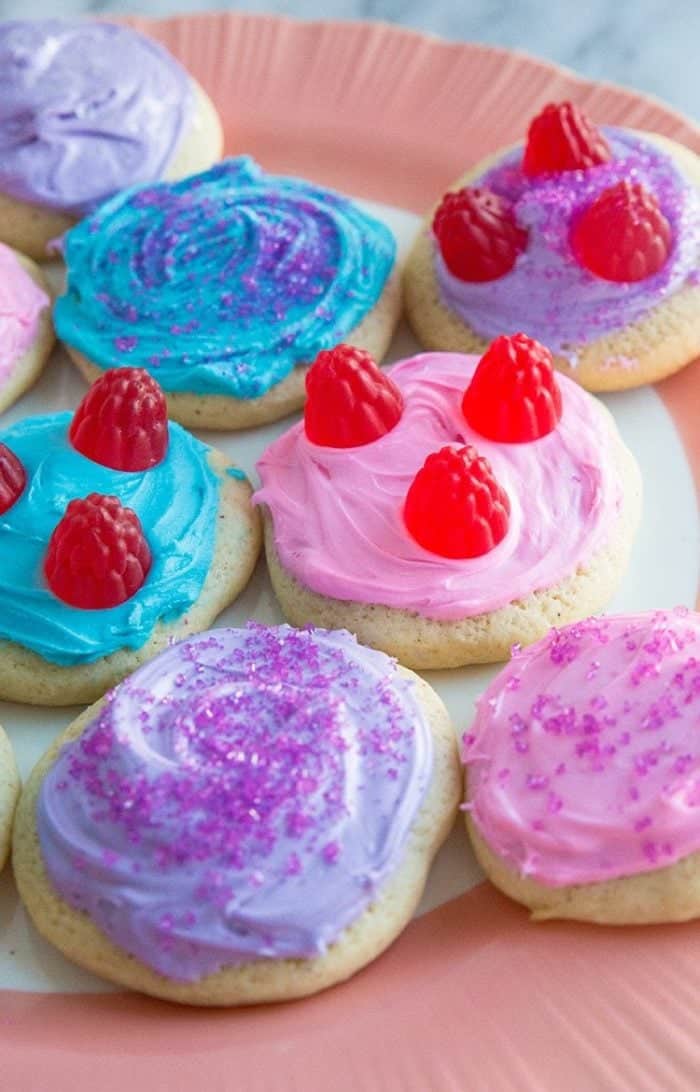 close up plate of colorful Old Fashioned Cut-Out Sour Cream Sugar Cookies with different toppings