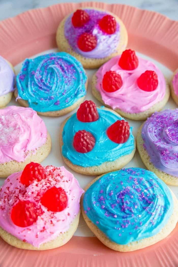 close up plate of colorful Old Fashioned Cut-Out Sour Cream Sugar Cookies with different toppings