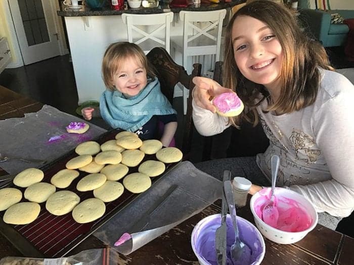 adding frosting cream to Sugar Cookies