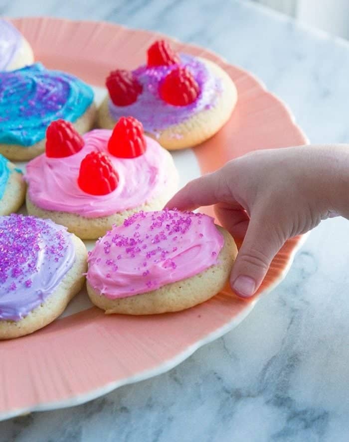 getting a piece of Cut-Out Sour Cream Sugar Cookies