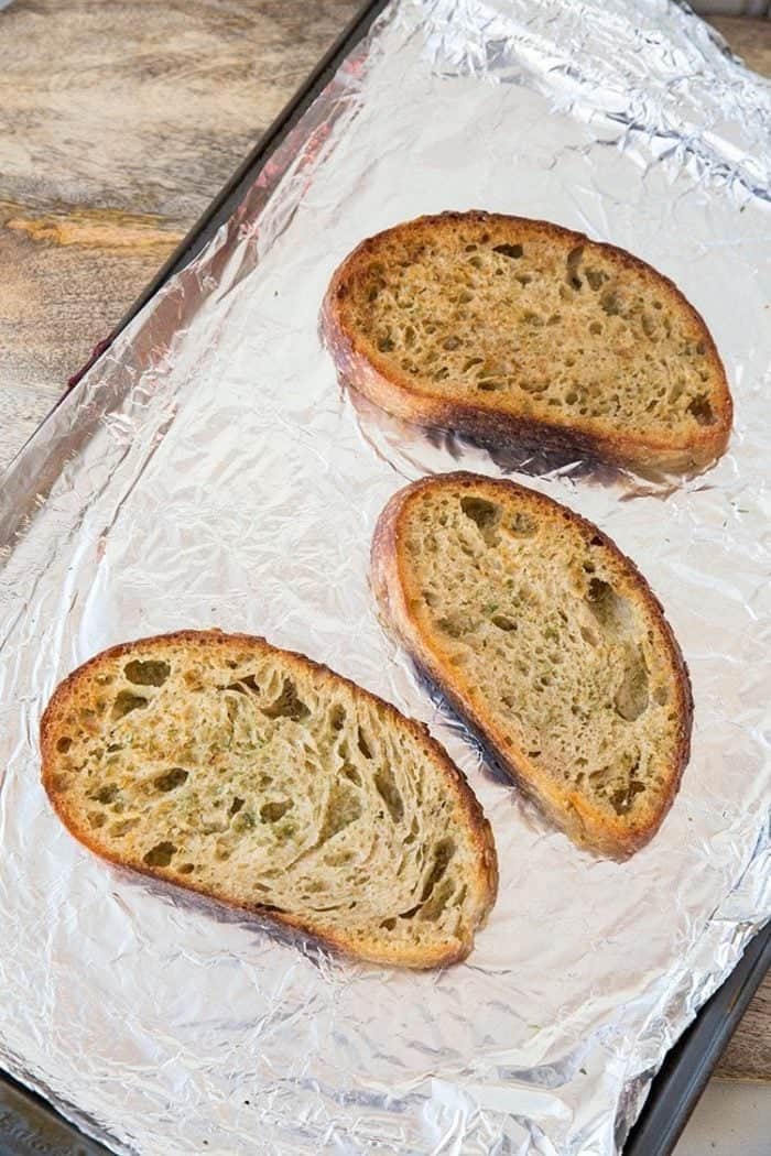 Three Pieces Garlic Bread in baking sheet with tinfoil 