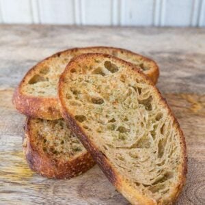 Close up Slices of Homemade Garlic Bread Using Sourdough in wood background