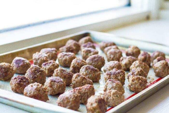 Rolled meatballs on a baking sheet