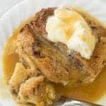 slices of Bread and Butter Pudding with caramel sauce in a white plate on marble background