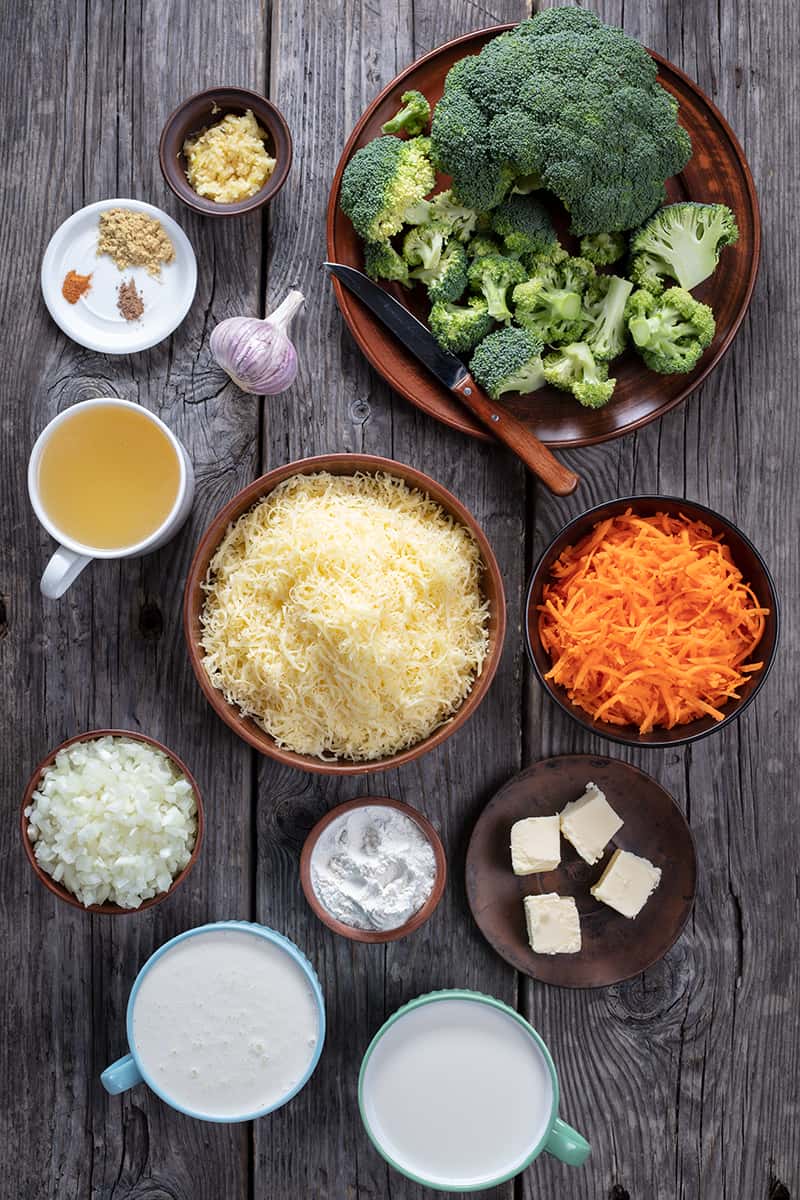 ingredients of broccoli cheese soup on a wood background