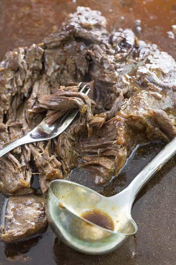 Close up A fork and ladle soup spoon in Instant Pot Roast with Gravy