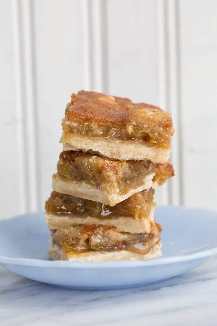 close up stack of Butter Tart Bars in a dessert plate on white background