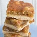 close up stack of Butter Tart Bars in a dessert plate on white background