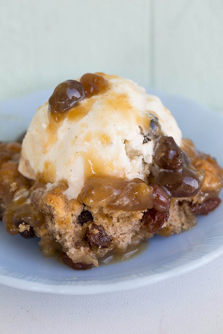 Magic Caramel Pudding Cake with a scoop of vanilla ice cream on top