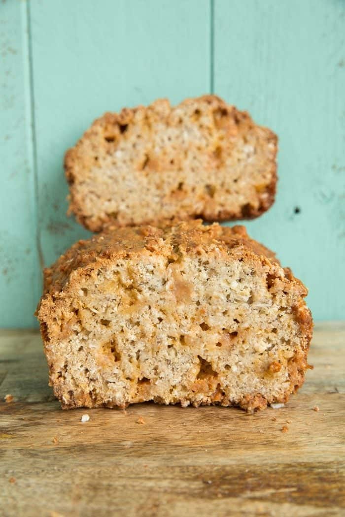 Sliced Butterscotch Oatmeal Banana Bread on jade green background