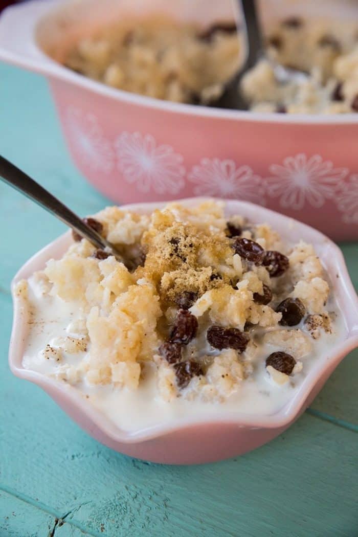 Baked Rice Pudding with raisins and sugar in a pink bowl