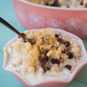Baked Rice Pudding with raisins and sugar in a pink bowl