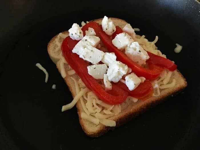 bread with sliced red pepper and cheese on top