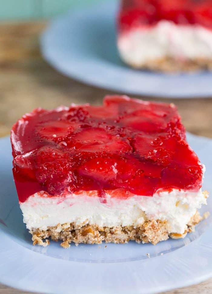 close up Strawberry Pretzel Salad slice in a blue dessert plate