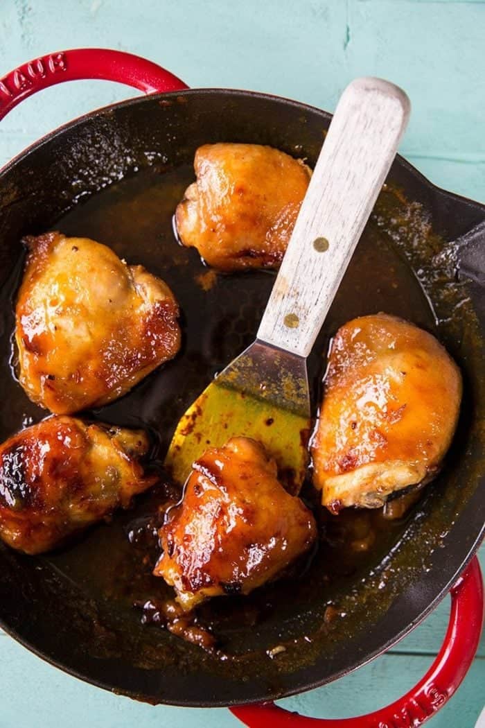 Close up of Five Pieces Sweet Honey Curry Chicken in a Large Red Skillet