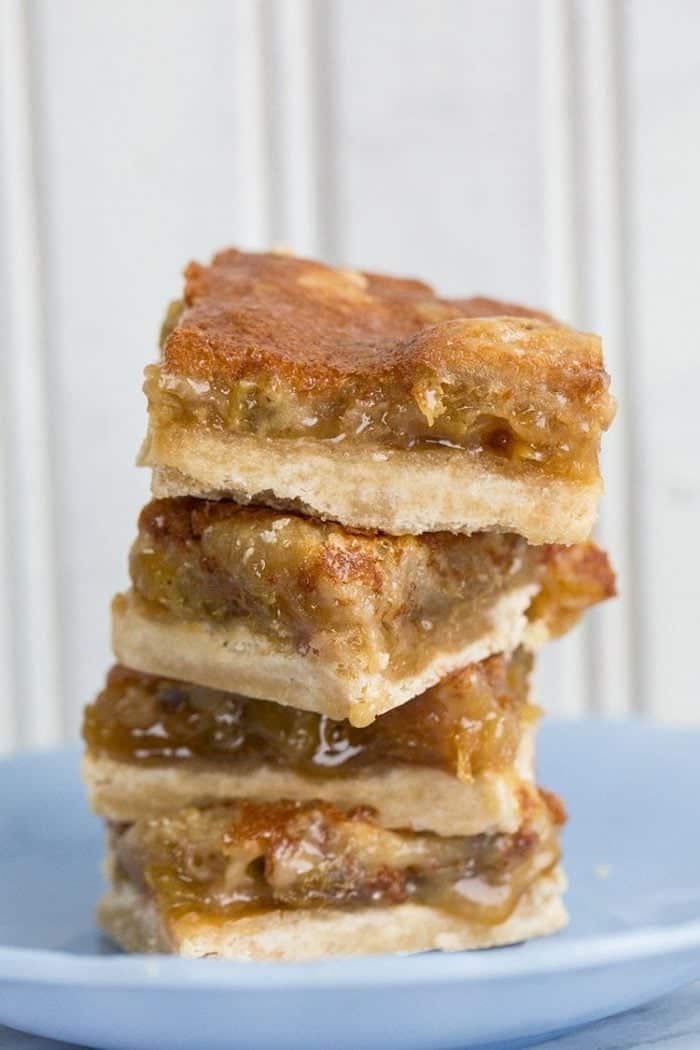 close up stack of Butter Tart Bars in a dessert plate on white background