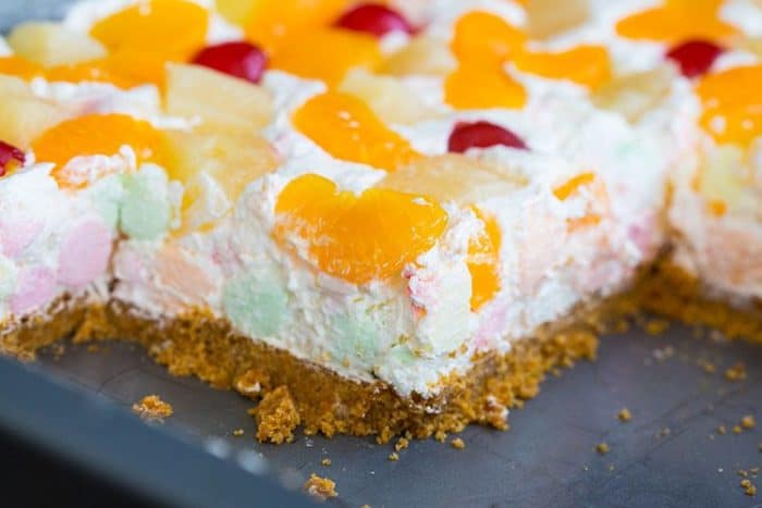 Ambrosia Salad Squares Topped with Mandarin Slices, Pineapple Chunks and Maraschino Cherries