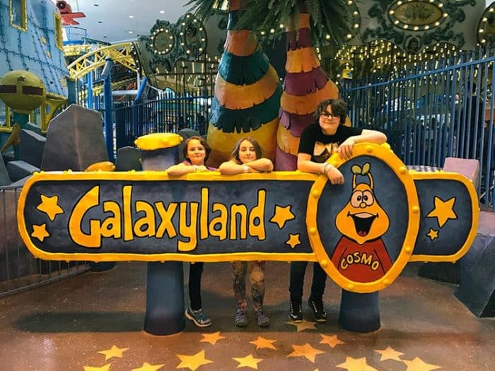 big Galaxyland signage in front of three kids