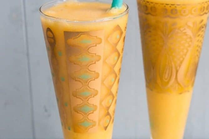 Close up Glasses of Mango Margarita with jade blue straws