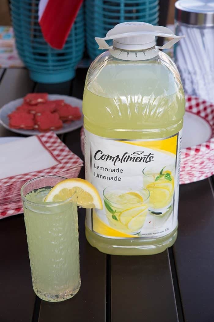 Compliments lemonade in a glass with a slice of lemon on top