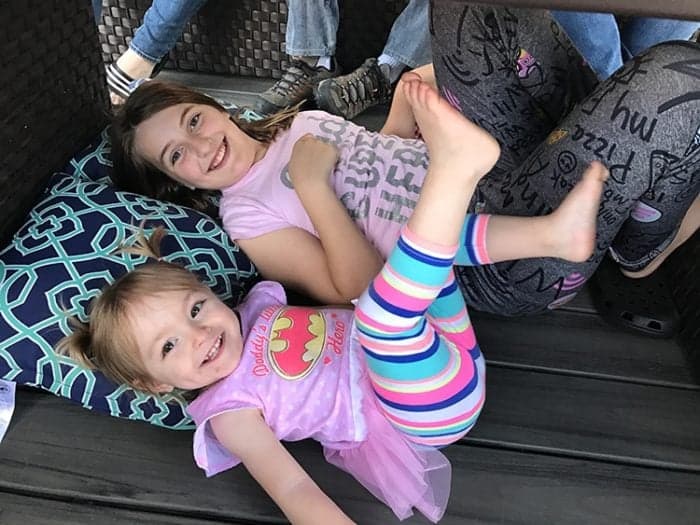 two little girls laying with feet up