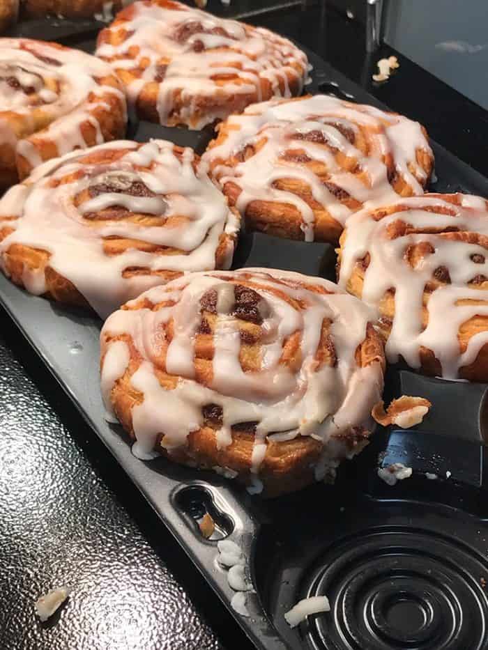 close up of cinnamon buns with white glaze