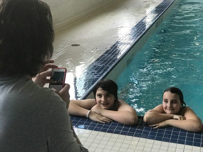 kids at the side of the pool having picture
