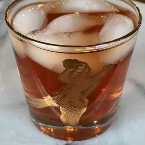 vintage bird glass with ice and Mickie Walker Cocktail on marble background