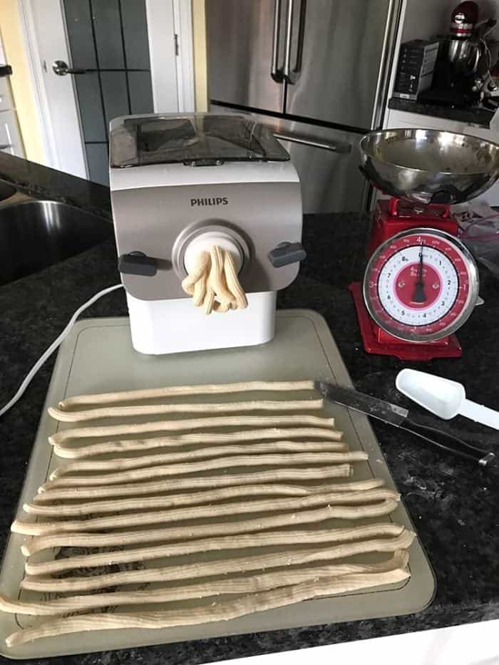 Philips Pasta Maker releasing the dough, laying the long tubes and letting them dry