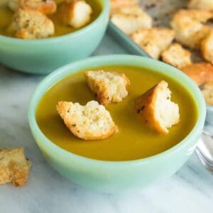 close up bowls of Vegan Curried Split Pea Soup topped with Homemade Garlic Croutons