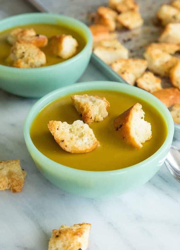 close up bowls of Vegan Curried Split Pea Soup topped with Homemade Garlic Croutons 