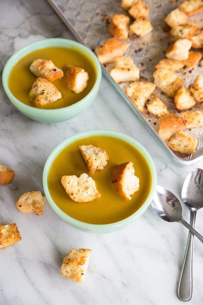 top down shot of bowls with Vegan Curried Split Pea Soup topped with Homemade Garlic Croutons 