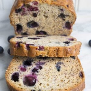 a loaf of Blueberry Banana Bread with 2 slices