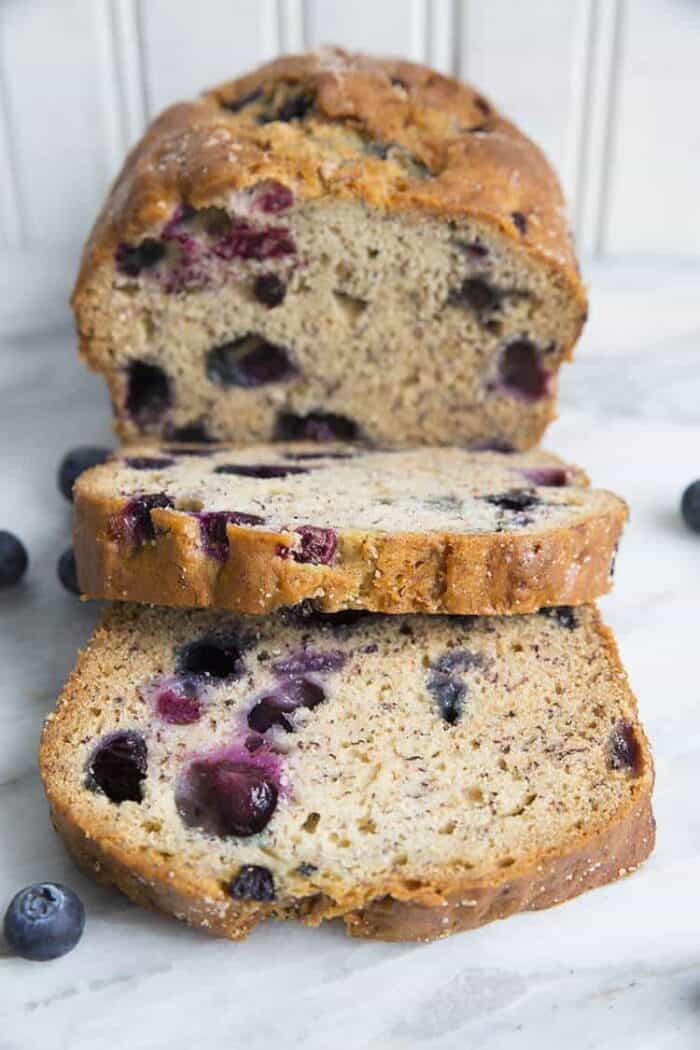 a loaf of Blueberry Banana Bread with 2 slices